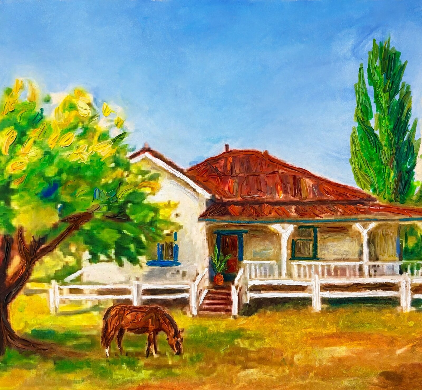Horse grazing by a red-roofed homestead