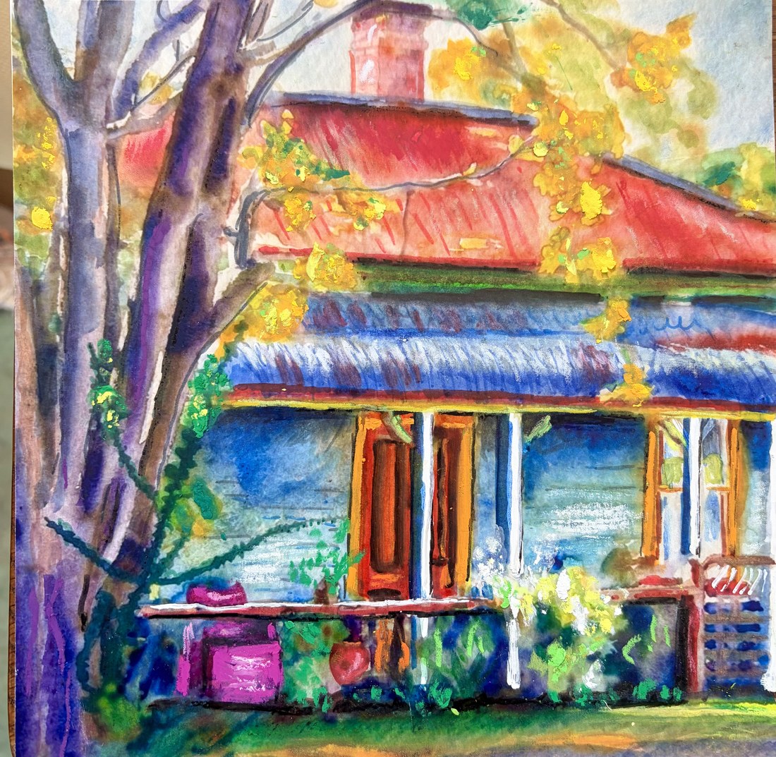 Red-roofed verandah cottage with autumn tree